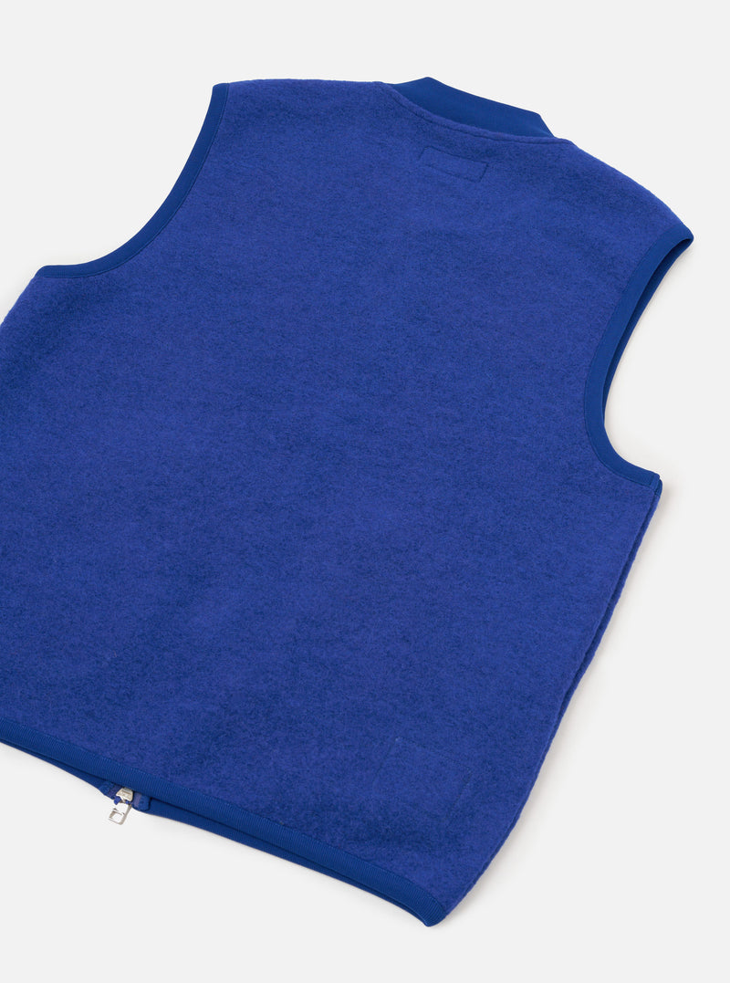 Front view of the Universal Works Blue Wool Fleece Zip Waistcoat displayed on a plain white background. Prominent features include a silver two-way zipper, ribbed neck collar, and two angled front patch pockets.