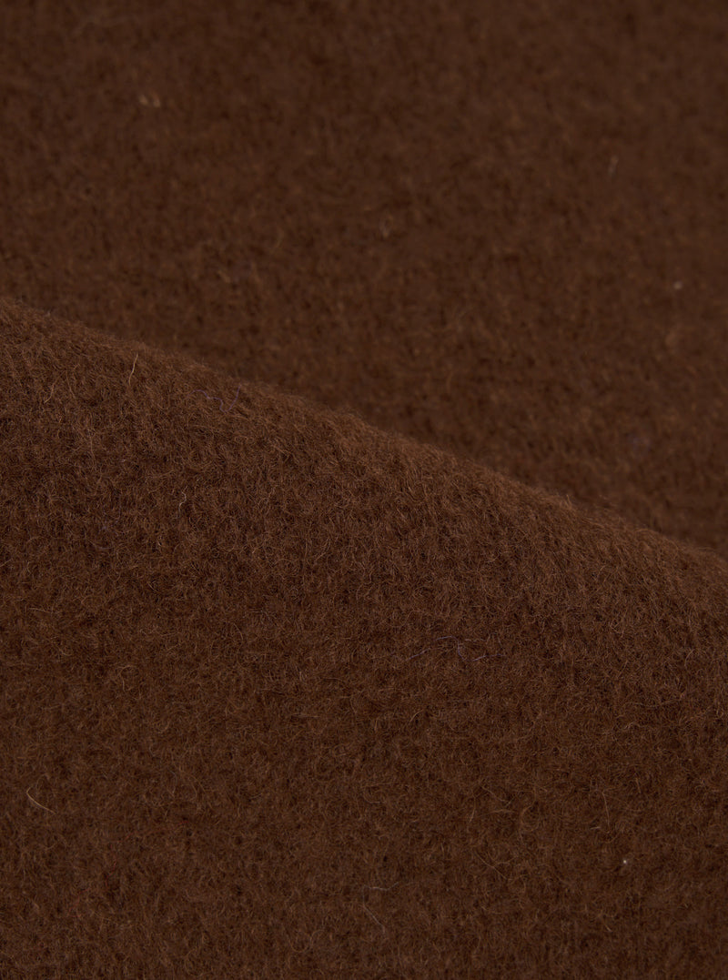 Extreme close-up fabric swatch image showcasing the texture of the Cacao Wool Fleece Zip Waistcoat. The detailed shot highlights the rich brown tone, soft fibers, and cozy tactile feel of the wool fleece material.