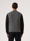 Back view of a model wearing a Grey Marl Wool Fleece Zip Waistcoat. The waistcoat is grey and made of wool fleece. The background is a plain white studio backdrop.