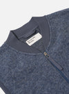 Close-up of the Slate Blue Wool Fleece Zip Waistcoat on a white background. The wool fleece texture is visible, along with the zip and ribbed collar.