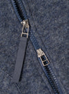 Close-up of the Slate Blue Wool Fleece Zip Waistcoat, showcasing the wool texture, zipper details, and slate blue color. The image is staged on a flat surface.