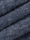 Close-up of the slate blue wool fleece zip waistcoat fabric. The soft, textured material is neatly folded, showcasing its rich color and cozy feel.
