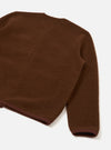 Cacao brown wool fleece cardigan photographed as a flat lay on a white surface. The close-cropped shot shows the back panel and one sleeve. The fabric has a soft, brushed texture. A darker brown ribbed trim is visible at the hem and cuff.