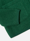 Close-up of the Green Wool Fleece Cardigan sleeve and pocket, showcasing the material's texture and ribbed trim on a white background.