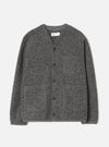 Grey marl wool fleece cardigan laid flat on a light grey seamless backdrop. Collarless V-neckline with a Universal Works woven label at the back neck. Five dark horn buttons down the centre front. Four patch pockets: two chest, two hip. Relaxed fit with long sleeves and a straight hem.