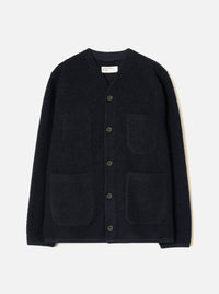 Navy wool fleece cardigan laid flat on a light grey studio backdrop. Collarless V-neckline with a woven brand label at centre back neck. Five dark buttons fasten the front placket. Four large patch pockets sit across the chest and lower front. Finished hem and cuffs in a smoother navy fabric.