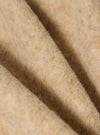 Close-up of the Fawn Wool Fleece Field Jacket. The soft, fawn-colored wool is folded, showing its texture. The image is tightly cropped, highlighting the material.
