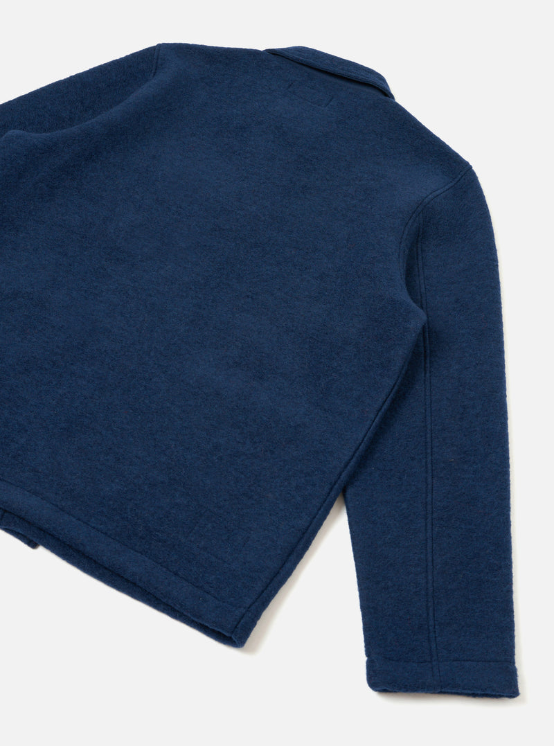 Rear view of the Indigo Wool Fleece Field Jacket presented against a plain white background. Highlights the soft deep blue fleece fabric, clean back paneling, straight hemline, and full sleeve construction.