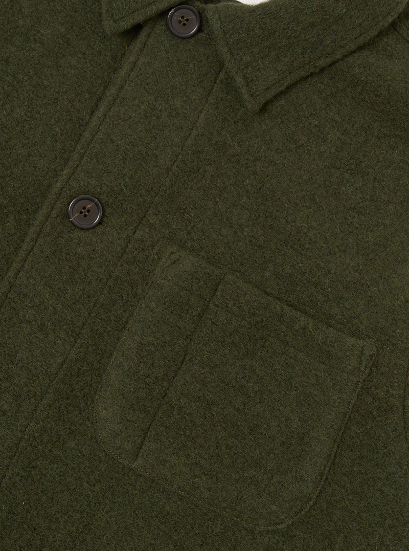 Side view of the Olive Wool Fleece Field Jacket displayed against a plain background. The olive green wool fleece fabric, structured jacket cut, chest pockets, and button placket are clearly visible.