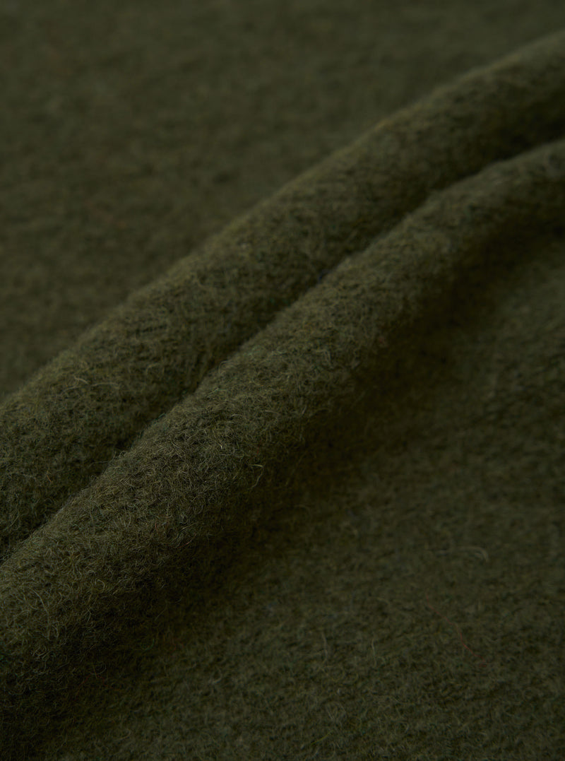 Extreme close-up fabric swatch image showcasing the texture of the Olive Wool Fleece Field Jacket. The shot highlights the rich olive green tone, soft fuzzy fibers, and warm tactile feel of the fleece material.
