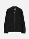 Black wool fleece zip bomber jacket, flat lay on a light grey seamless backdrop. Ribbed bomber collar with a Universal Works label visible at the neckline. Full-length silver zip with a leather pull tab. Textured boiled wool fleece body, two front welt pockets, and ribbed cuffs at the hem of each sleeve.