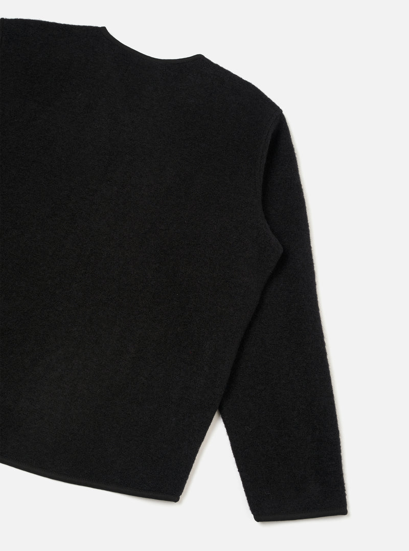 Rear view of the Black Wool Fleece Zip Liner Jacket presented flat against a white background. The image showcases the clean back construction, soft black wool fleece material, neatly finished hem, and binding details.