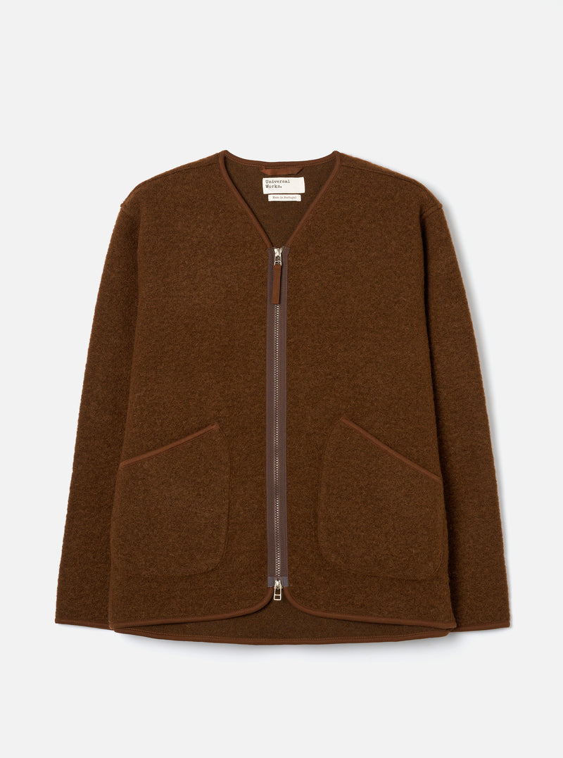 Cacao brown wool fleece zip liner jacket laid flat on a light grey studio backdrop. Collarless V-neckline with tonal bound edging, full-length silver metal zip, and two patch pockets at the lower front. Textured boiled wool fleece fabric throughout. Universal Works woven label visible at the neck.