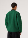 Back view of a model wearing a Green Wool Fleece Zip Liner Jacket. The jacket is green wool with a black collar, against a white background.