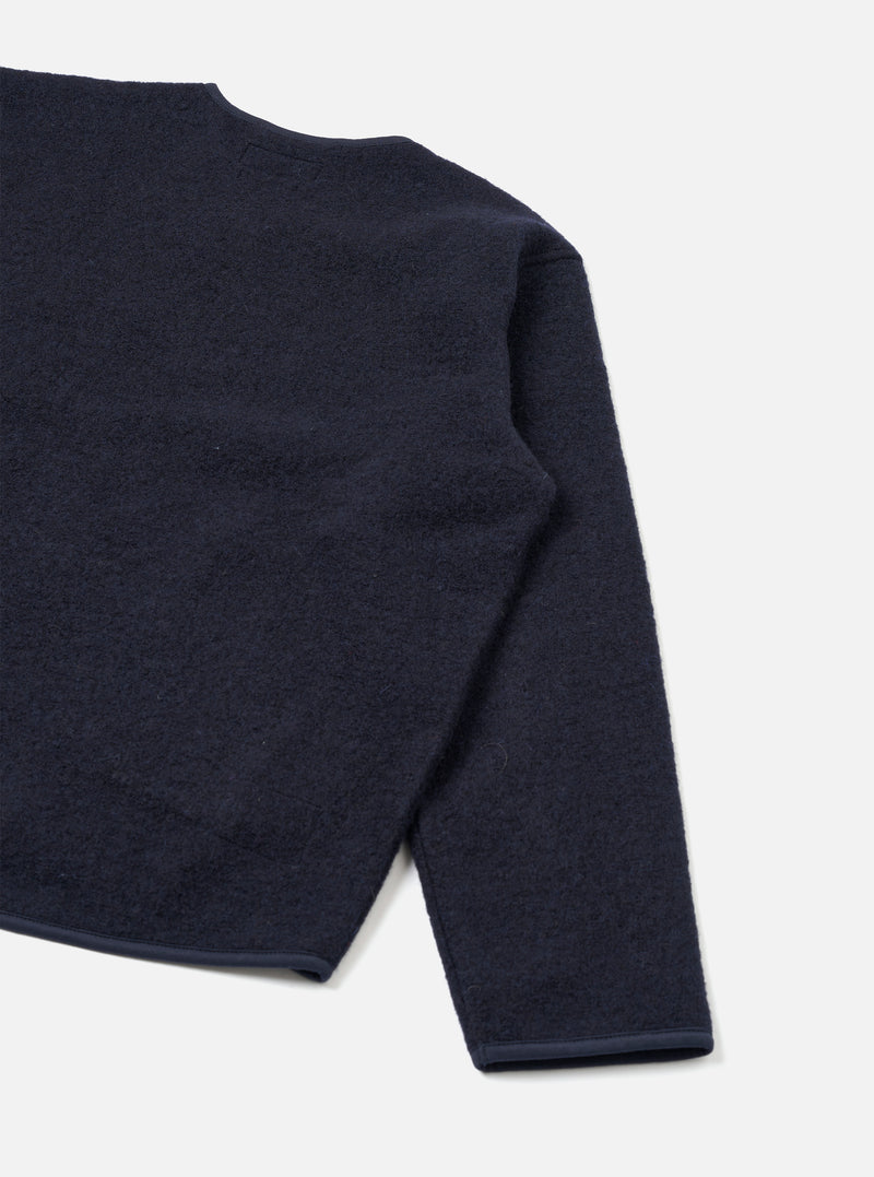 Rear view of the Navy Wool Fleece Zip Liner Jacket presented flat against a white backdrop. The shot showcases the clean back construction, navy blue wool fleece texture, and neatly edged sleeve cuffs and hem.