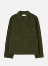 Olive wool fleece uniform jacket laid flat on a light grey studio backdrop. Features a pointed collar, five dark buttons down the centre front, one chest patch pocket and two large lower patch pockets. Ribbed cuffs and a straight hem are visible. A Universal Works woven label sits inside the collar.