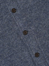 Close-up of the Slate Blue Wool Fleece Uniform Jacket showing the texture of the wool fleece and the buttons. The jacket is on a flat surface.