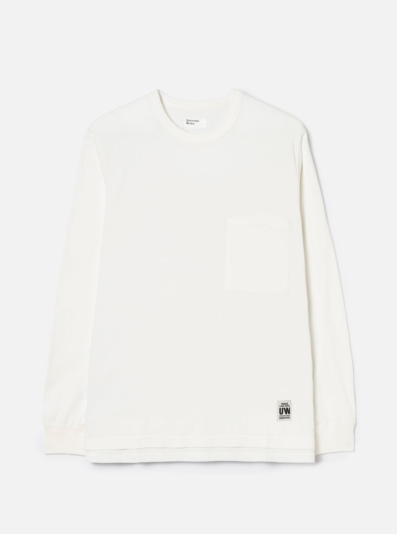 Ecru long-sleeve pocket tee in single jersey cotton, shot flat on a light grey seamless backdrop. Features a crew neck, one chest patch pocket, and ribbed cuffs. A Universal Works woven label sits at the interior neck and a small branded UW tab is stitched at the lower hem.