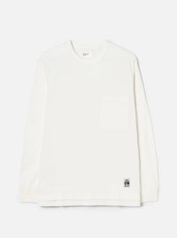 Ecru long-sleeve pocket tee in single jersey cotton, shot flat on a light grey seamless backdrop. Features a crew neck, one chest patch pocket, and ribbed cuffs. A Universal Works woven label sits at the interior neck and a small branded UW tab is stitched at the lower hem.