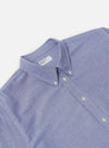 Close-up of the Blue Oxford Daybrook Shirt on a white background. The shirt is neatly folded, showcasing its button-down collar and crisp cotton fabric.