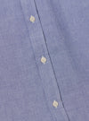 Close-up of the Blue Oxford Daybrook Shirt showing the blue oxford cotton fabric and button details. The shirt is neatly laid out on a flat surface.
