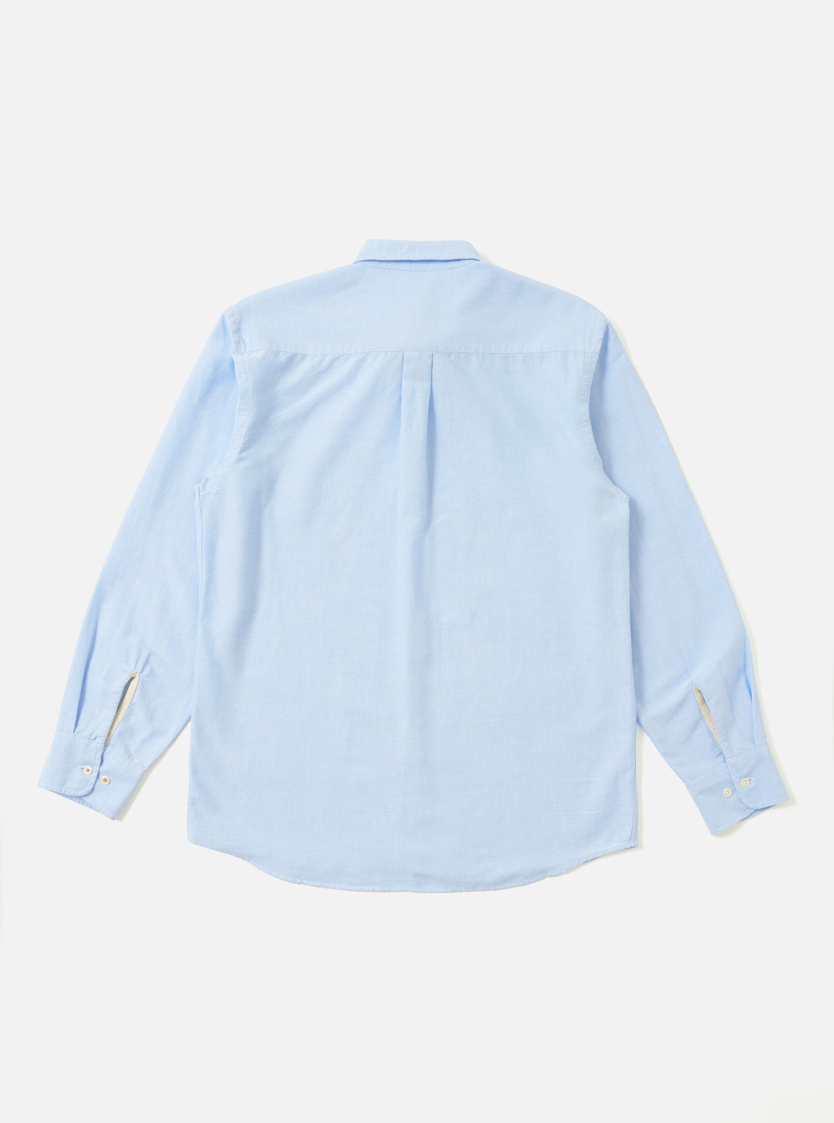 The back of a Sky Blue Oxford Daybrook Shirt laid flat on a white background. The shirt is long-sleeved with a button-down collar.