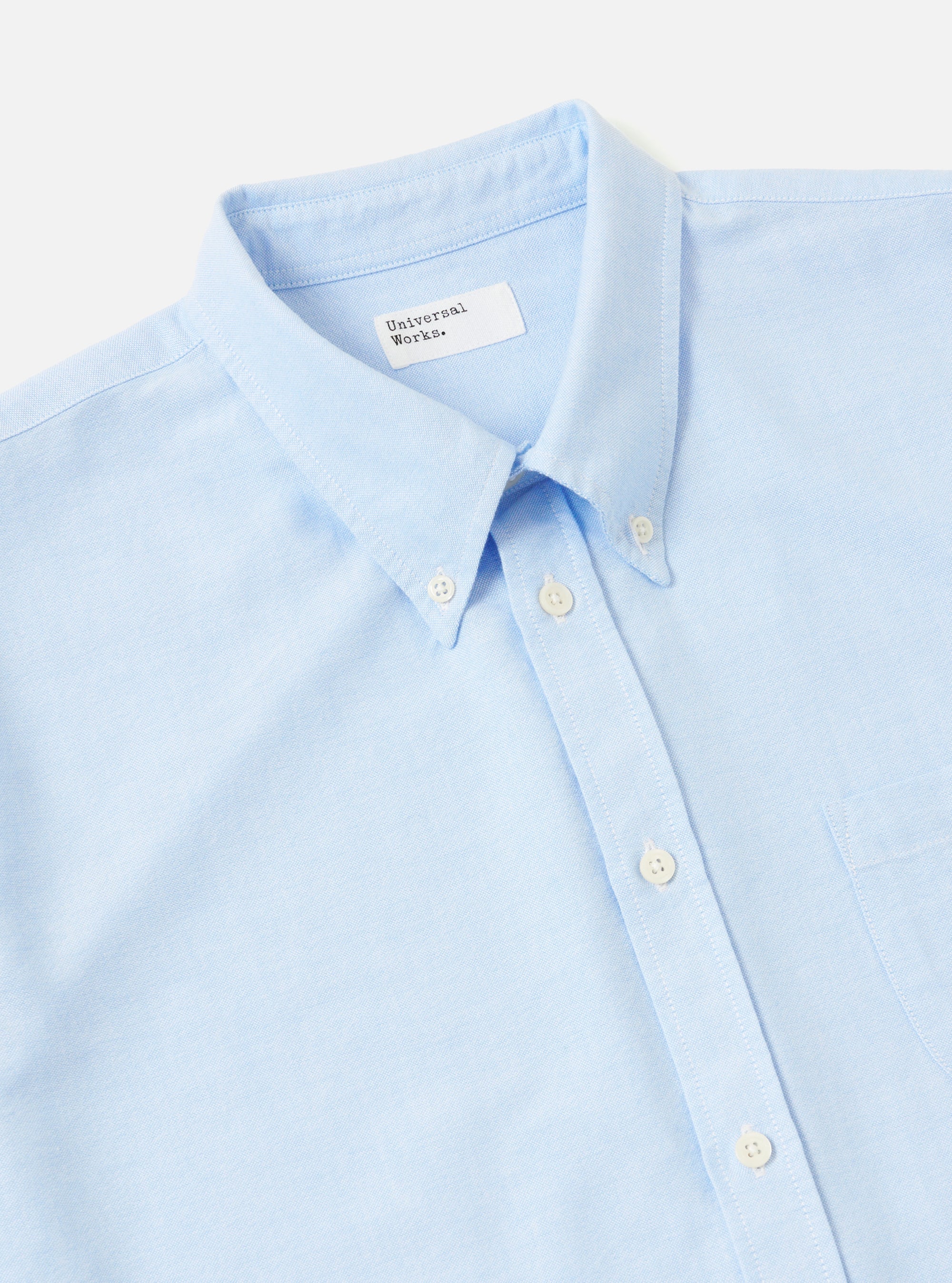 Close-up of the Sky Blue Oxford Daybrook Shirt on a white background. The light blue cotton shirt features a button-down collar and a chest pocket.