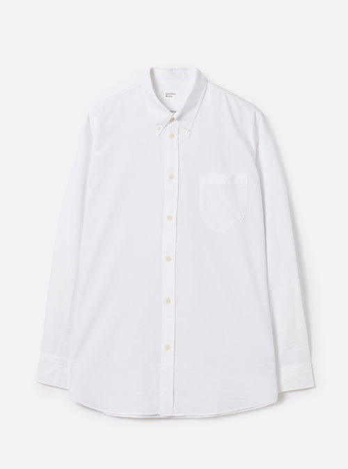Front view of the White Oxford Daybrook Shirt displayed flat against a plain white background. Highlights the button-down collar, single chest pocket, long sleeves, and crisp white organic cotton oxford fabric construction.
