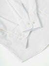 Close-up of the White Oxford Daybrook Shirt showing the cuff and button details. The shirt is neatly folded on a white surface.