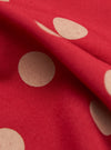 Close-up of the Red Bold Dot Print Rayon Scout Scarf. The scarf is red with large, off-white polka dots. The rayon fabric has a soft, flowing drape. Shot on a plain surface.
