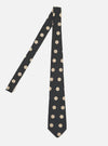 A Black Bold Dot Print Rayon Tie is displayed on a white background. The tie features a black rayon material with bold, light tan polka dots. The tie is laid out to show its full length.