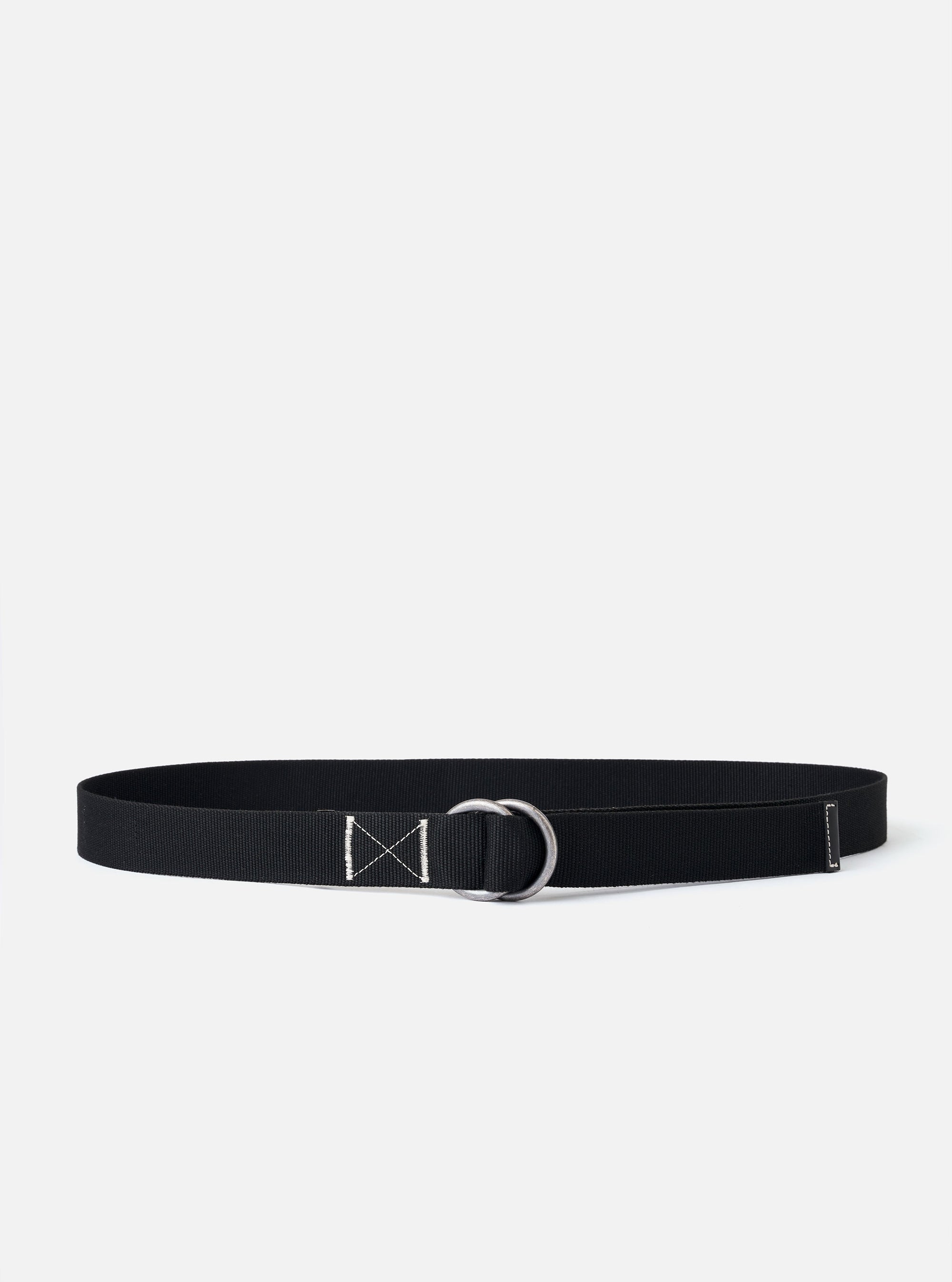 The Black Canvas Webbing O Ring Belt is shown as a flat lay against a white background. The belt is made of a black woven fabric and features two silver-tone metal O-rings at one end for closure.