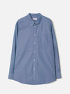 Front view of the Indigo Prince Chambray Daybrook Shirt laid flat on a light grey studio backdrop. Features a spread collar, full button placket with white buttons, a single chest patch pocket, and long sleeves with buttoned cuffs.