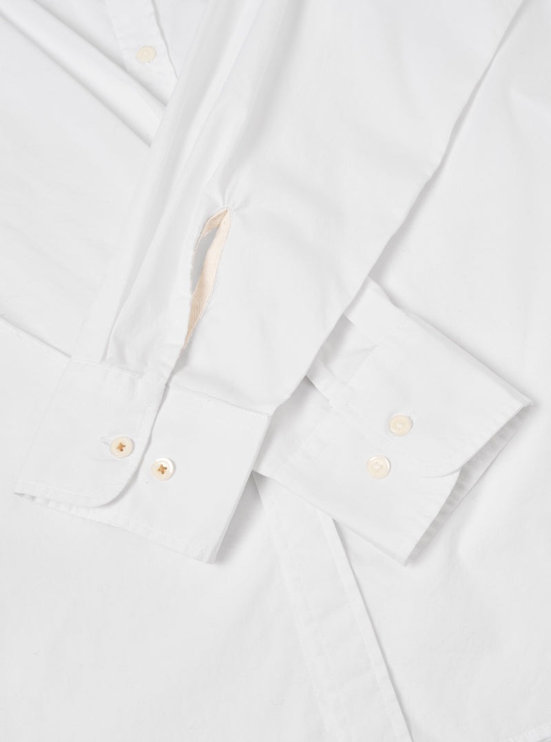 Rear view of the White Prince Chambray Daybrook Shirt laid flat against a plain white backdrop. The image highlights the clean back yoke, neat shoulder seam stitching, and crisp white cotton chambray fabric construction from behind.