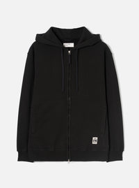 Black zip-through hoodie in brushback sweat fabric, laid flat on a white studio backdrop. Features a jersey-lined hood with navy drawcords, a full-length metal zip, two large patch pockets, and ribbed cuffs and hem. A small woven UW brand label sits at the lower right front.