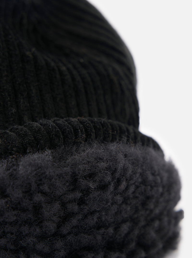 Close-up of the cableami® Black Corduroy 5w Cap showing the corduroy texture and soft lining against a white background.