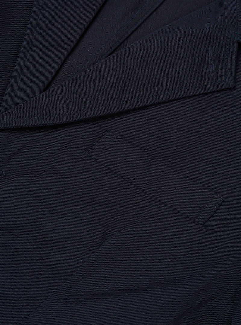 Detailed close-up shot of the Navy Twill London Jacket on a plain light background, highlighting the fabric weave, internal pocket details, button construction, and dark navy twill cotton finish.
