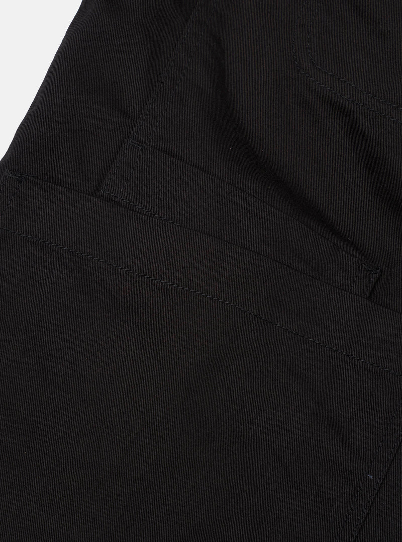 Detailed shot of the inside lining and fabric texture of the Black Twill Bakers Chore Jacket on a neutral background, showing the internal pocket, neat seam stitching, and dark black cotton twill finish.