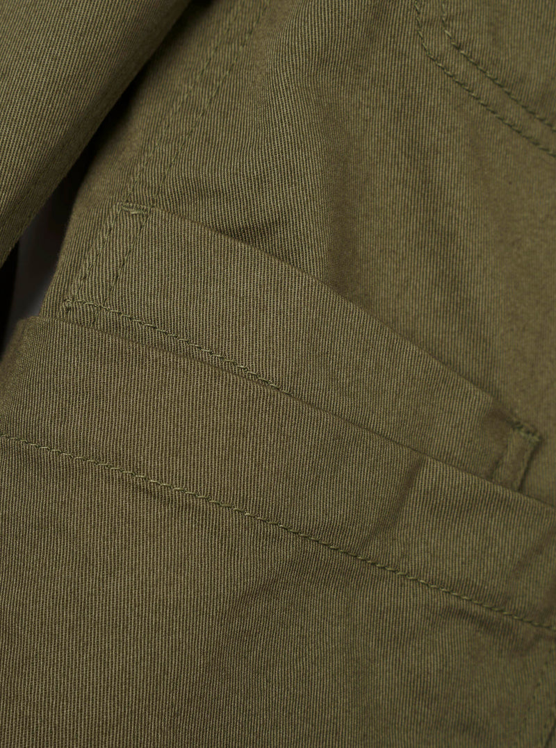 Interior detail image of the Light Olive Twill Bakers Chore Jacket on a neutral background, highlighting the internal pocket construction, finished inner seams, and light olive green twill cotton fabric.