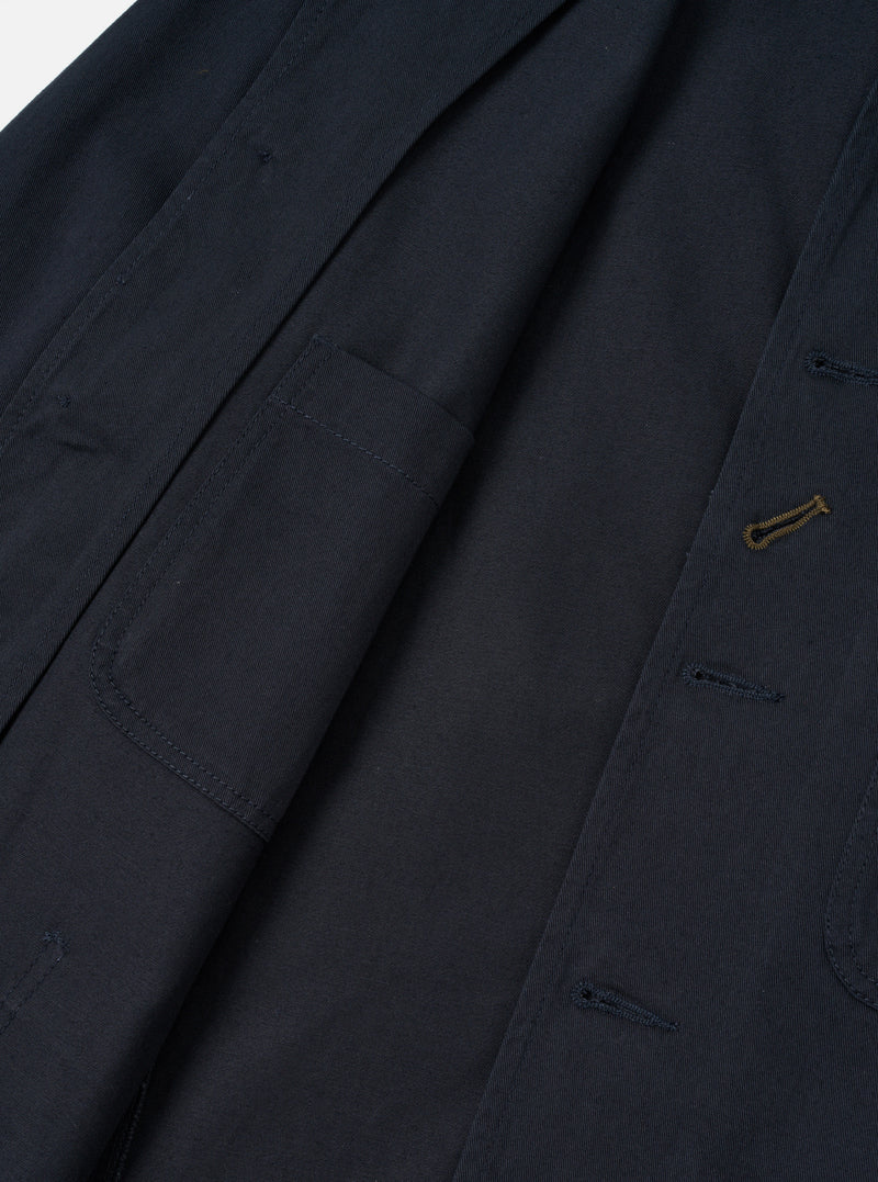 Close-up detail shot of the Navy Twill Bakers Chore Jacket against a plain white background. Focuses on the button placket, signature diagonal buttonhole, collar, and chest pocket on dark navy twill.