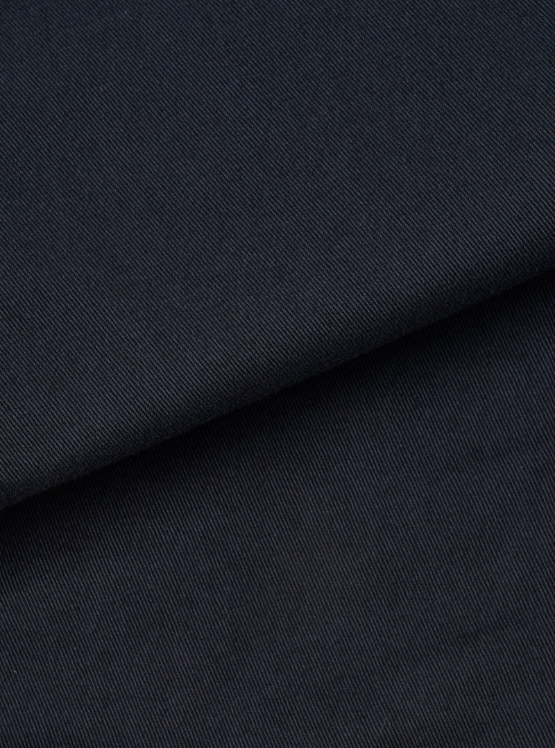 Extreme close-up fabric swatch image showing the fine texture of the Navy Twill Bakers Chore Jacket. Details the diagonal weave pattern, durable structure, and deep navy color of the cotton twill fabric.