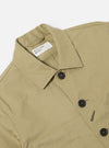 Close-up of the Sand Twill Bakers Jacket on a white background. The jacket is a light tan color and made of twill. It has a button-down front and a classic fit.