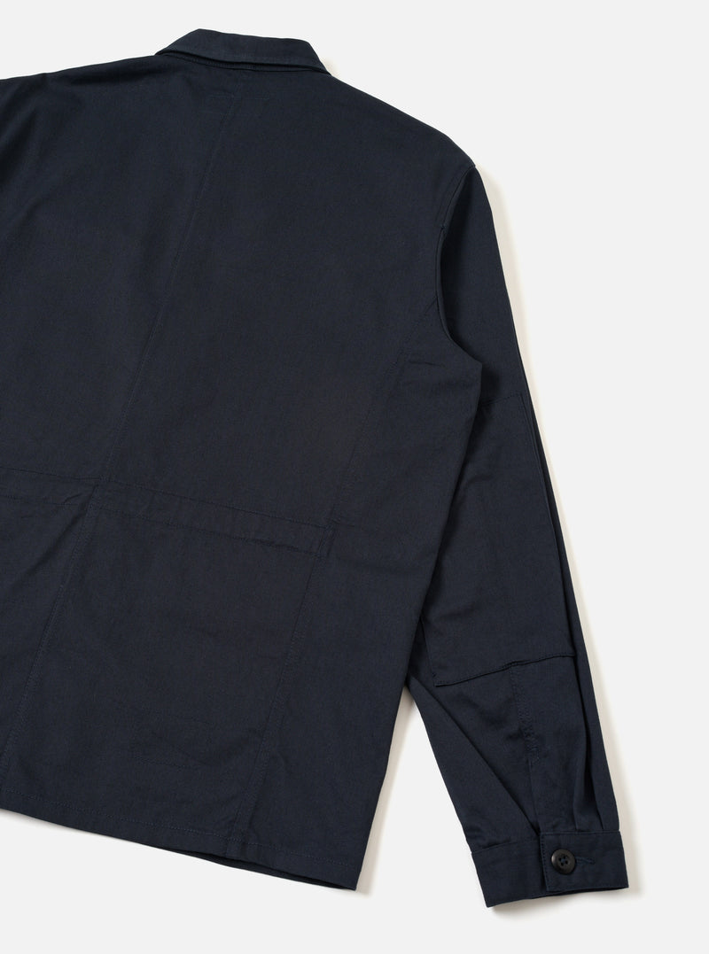 Back view of the Navy Twill MW Fatigue Jacket presented against a plain white background. Highlights the plain navy blue twill back panel, straight hem line, and sleeve cuff button fastenings clearly.