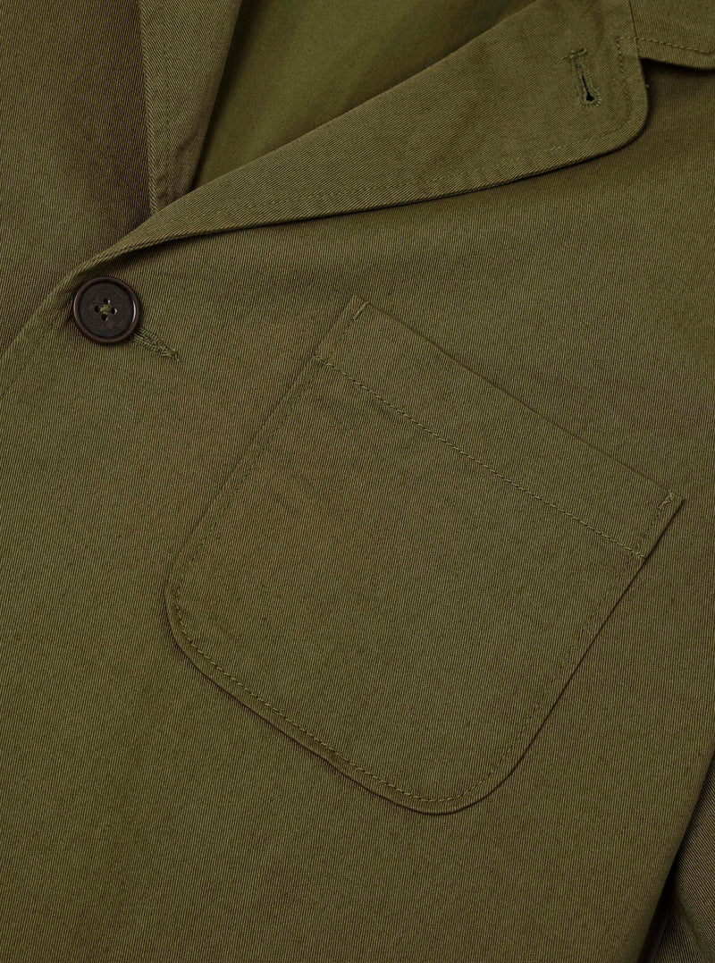 Close-up detail of the Light Olive Twill Three Button Jacket set against a neutral studio background, showcasing the fabric's diagonal twill weave, button fastening, and lapel stitching.