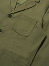 Close-up of a light olive twill three button jacket. The jacket is neatly displayed, highlighting the fabric and button details.