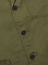 Close-up of the Light Olive Twill Three Button Jacket showing the twill texture, dark buttons, and pocket detail. The jacket is laid flat on a neutral surface.
