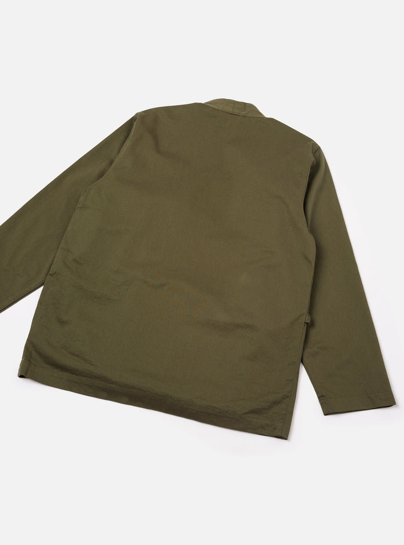 Back view of the Light Olive Twill Kyoto Work Jacket shown against a plain off-white studio background. Highlights the clean rear paneling, straight hemline, and relaxed shoulders of the garment.