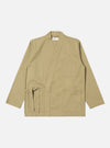 The Sand Twill Kyoto Work Jacket in a light tan color, laid flat on a white background. The jacket has a tie waist and patch pockets.