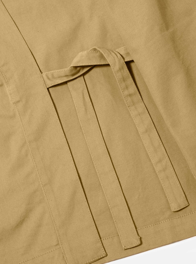 Detailed close-up shot of the Sand Twill Kyoto Work Jacket on a plain background. Focuses on the woven fabric texture, neat seam finishing, and internal fabric tie detail of the kimono work jacket.