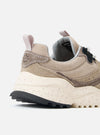 Close-up of the Flower Mountain Dove Hairy Velour/Suede Wave Man sneaker. Features beige suede and velour, a speckled sole, and a pull tab. Shot on a white background.